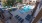 Large sparkling blue pool with a large pool deck and lounge chairs