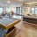 Spacious and well lit game room with billiard tables and plenty of seating.